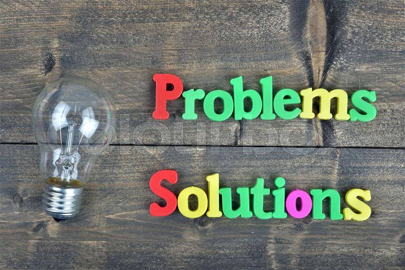 Problems and Solutions word on wooden table, stock photo