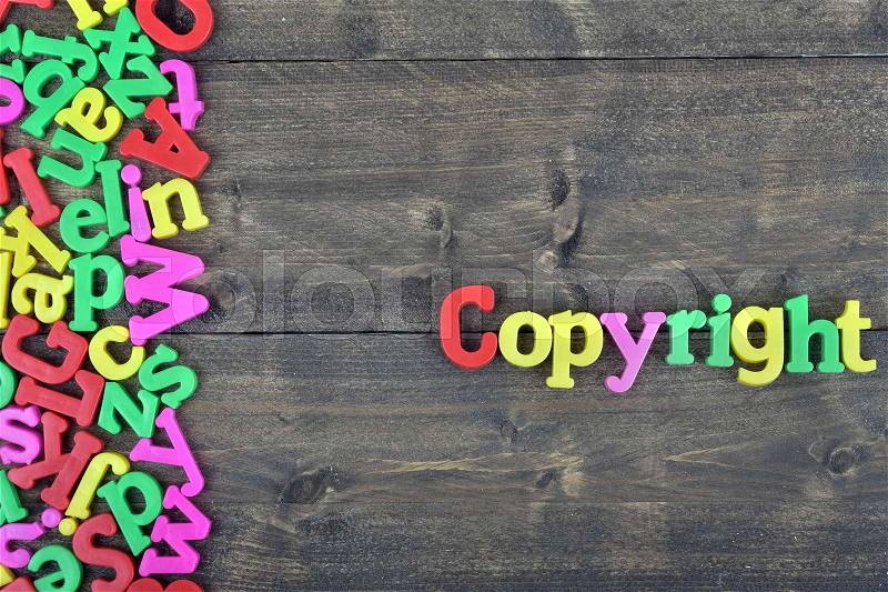 Copyright word on wooden table, stock photo