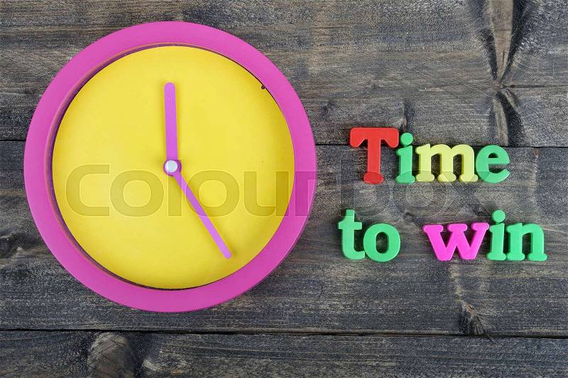 Time to win word on wooden table, stock photo