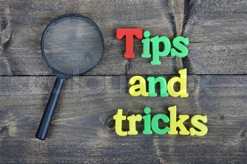 Tips and tricks word on wooden table, stock photo
