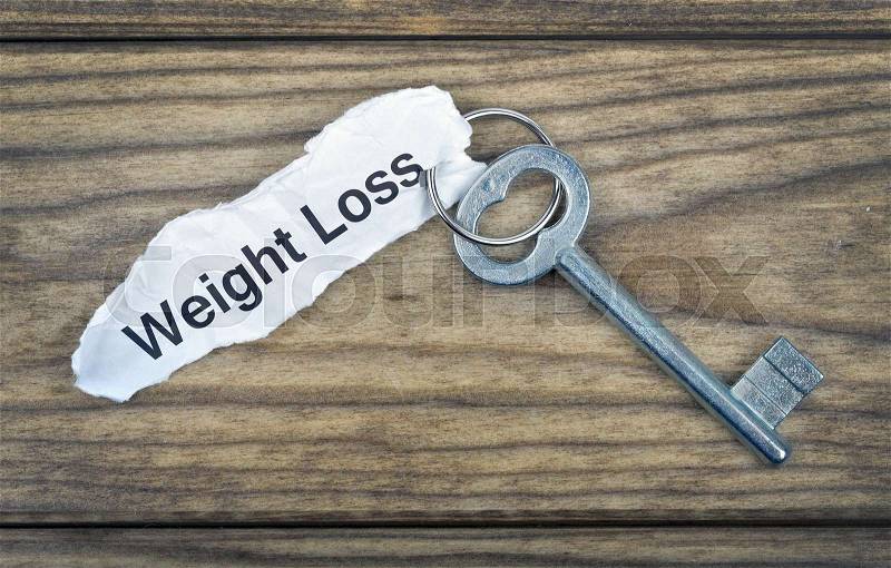 Key with message Weight Loss on wooden table, stock photo