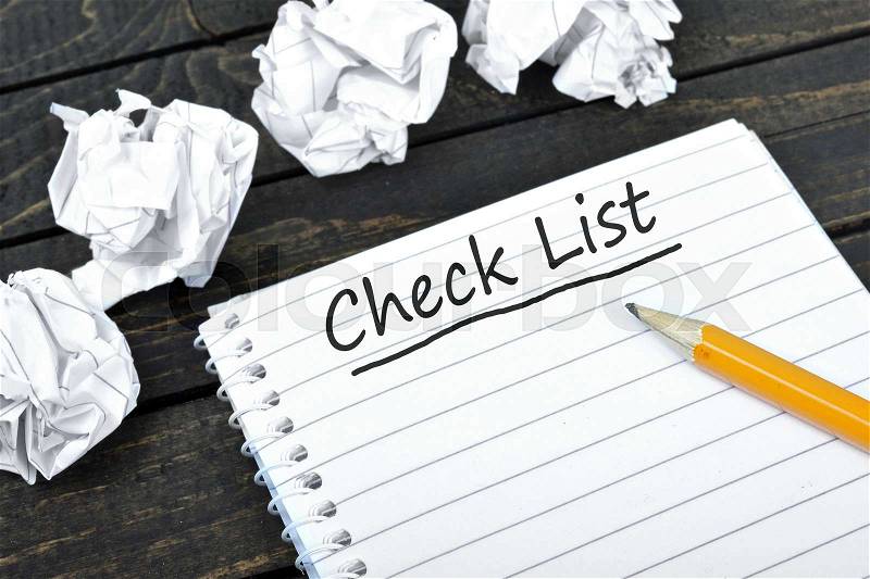 Check list on notepad and crippled paper, stock photo