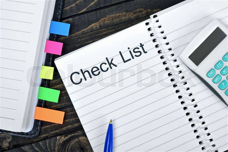 Check List text on notepad and hand calculator, stock photo