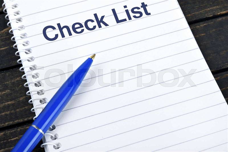 Check list text on notepad and blue pen, stock photo