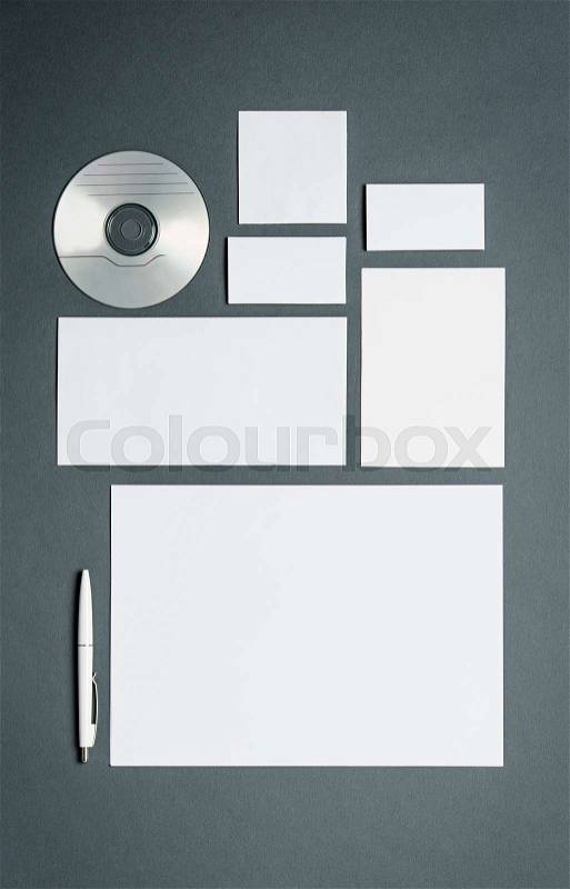 Mock-up business template with cards, papers, disk. Gray background, stock photo