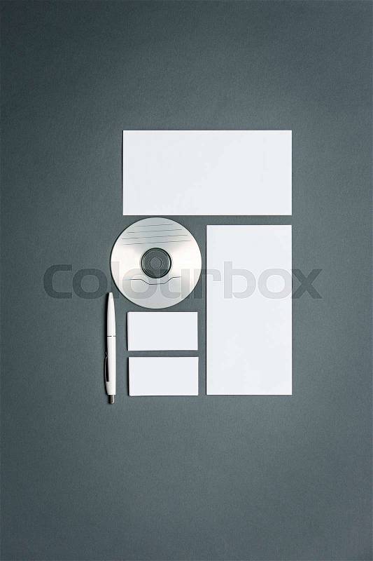 Mock-up business template with cards, papers, disk. Gray background, stock photo