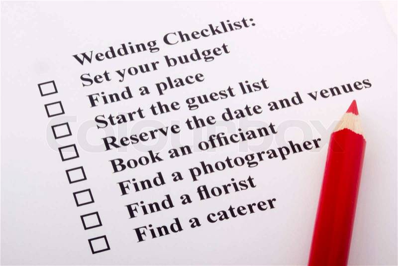 Red pencil laying on a wedding checklist, stock photo