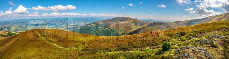 Panoramic summer landscape under blue sky with clouds. Path through hillside meadow on Borzhava mountain ridge in Carpathians, stock photo