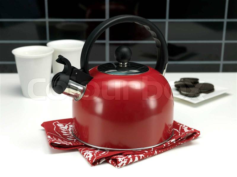 A stove top kettle on a kitchen bench, stock photo