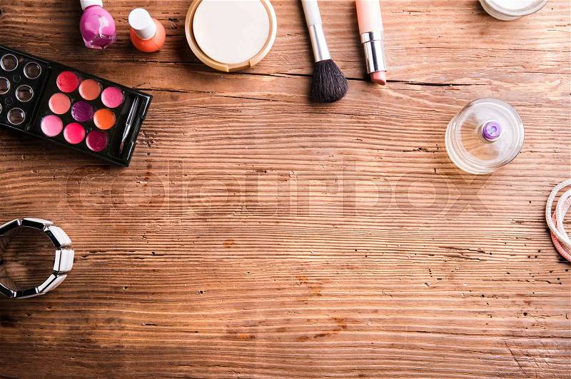 Various make up products laid on table. Studio shot on wooden background. Flat lay, copy space, stock photo