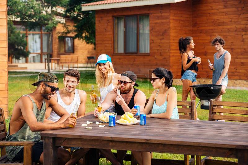 Group of happy young friends on outdoor summer party, stock photo