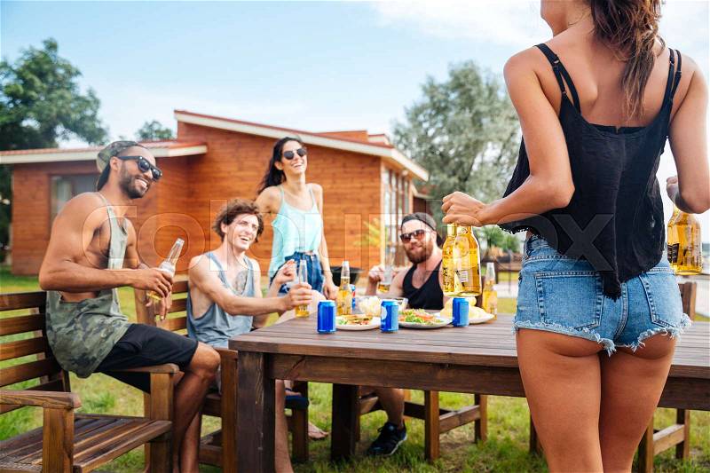 Teenage happy friends having picnic party outdoors, stock photo