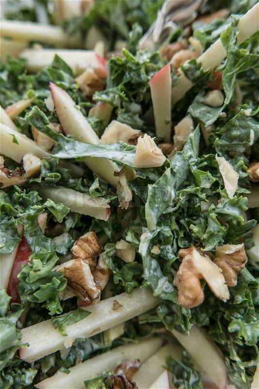 Kale salad with apples and walnuts, stock photo