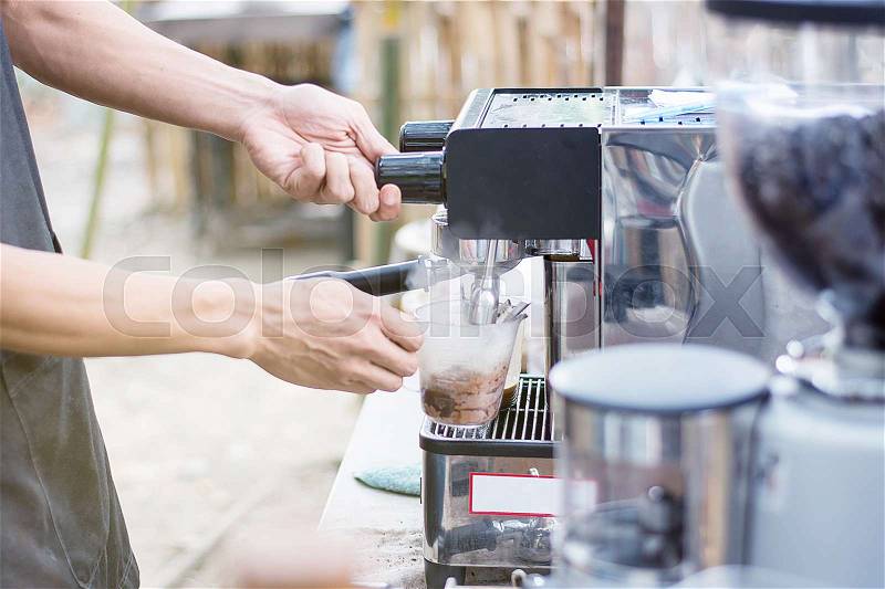 Barista mixing milk and chocolate on espresso machine for making coffee, Latte and cappuccino at the coffee machine at the coffee shop, stock photo