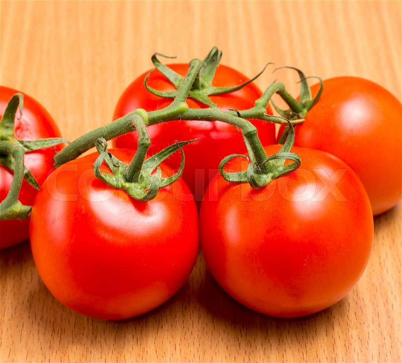 Freshly picked red tomatoes on the table top, stock photo