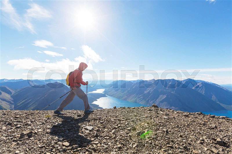 Hiking man in the mountains, stock photo