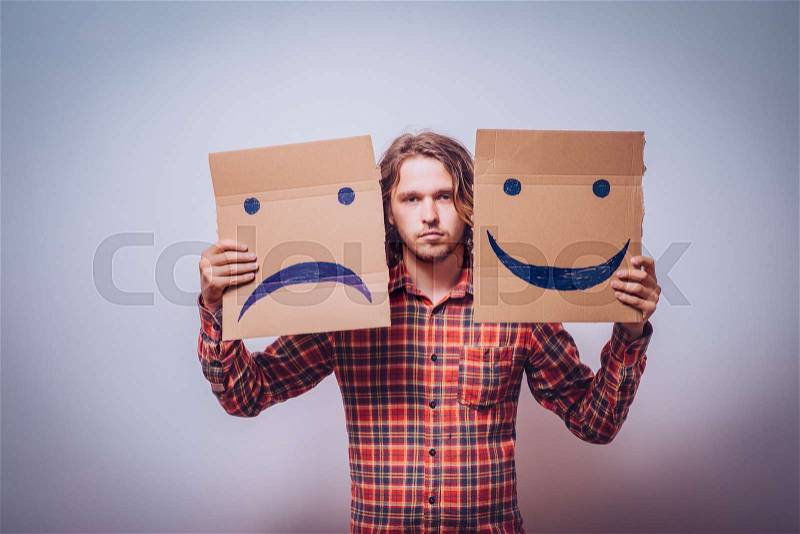 Conceptual image of a man changing his mood from bad to good, stock photo