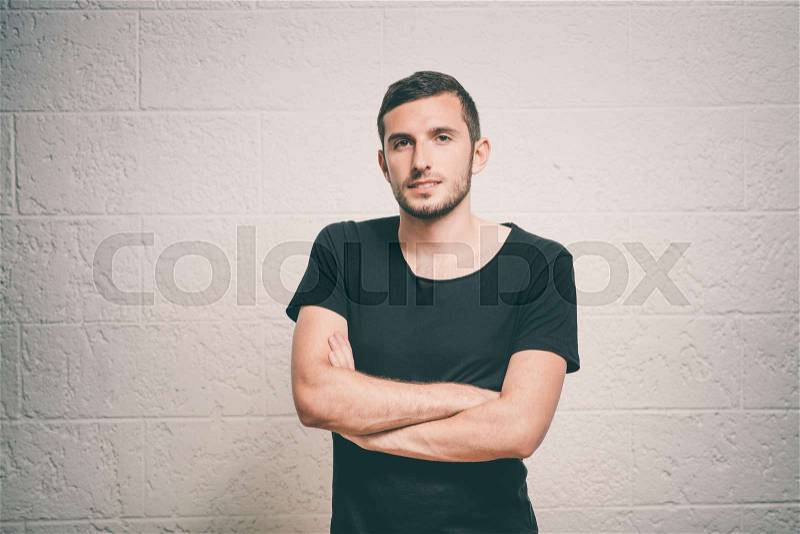 Portrait of a man arms folded, stock photo
