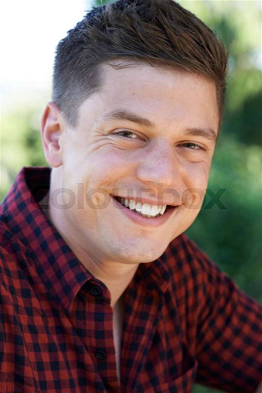 Outdoor Head And Shoulders Portrait Of Smiling Man, stock photo