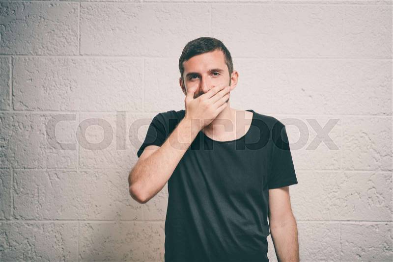 Man laughs and covers her mouth, stock photo