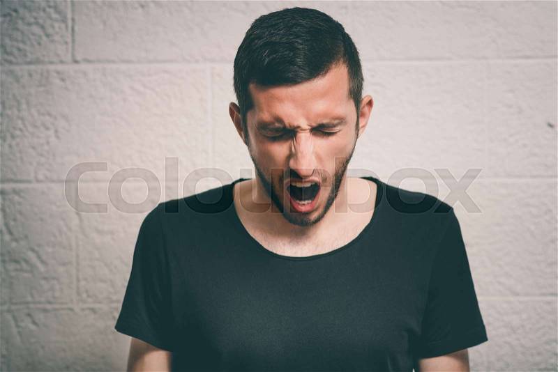Angry man screaming, stock photo