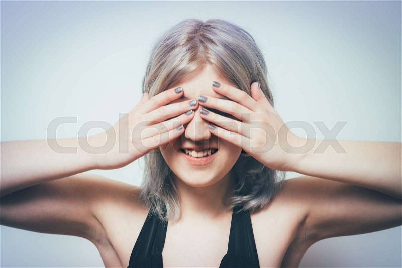 Woman covers his face by hand, stock photo