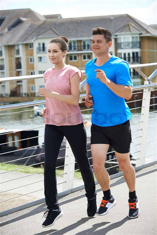 Young Couple Exercising In Urban Environment, stock photo