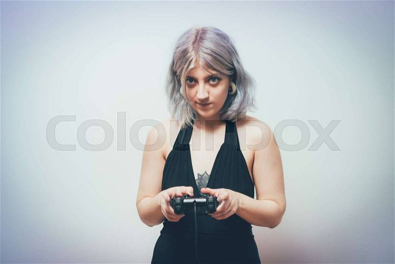 Woman playing on the joystick in a game console, stock photo