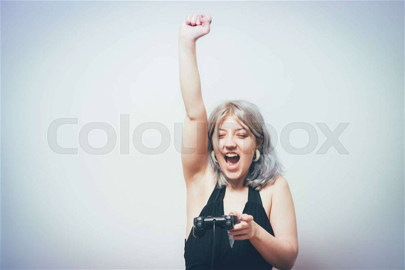 Woman playing on the joystick in a game console, stock photo