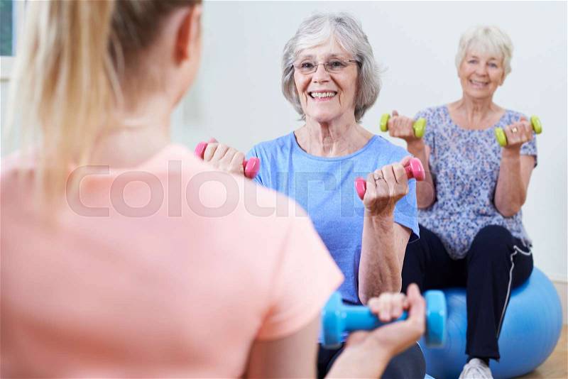Senior Women At Fitness Class With Instructor, stock photo