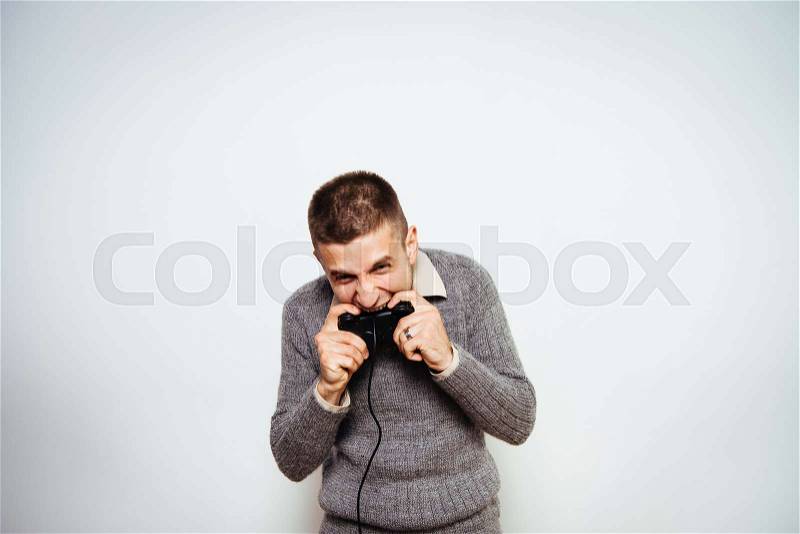Man playing on the joystick in a game console, stock photo