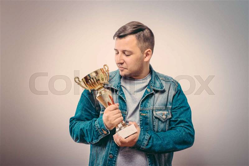Man with a golden cup, stock photo