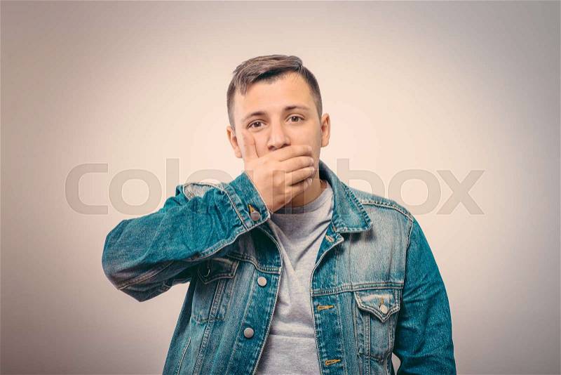 Man laughs and covers her mouth, stock photo