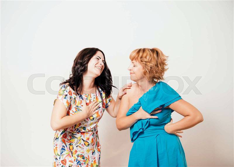 Two women feeling heart pain and holding her chest, stock photo