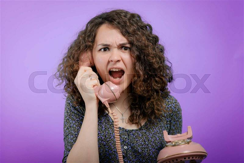 Portrait of a woman yelling at phone, stock photo