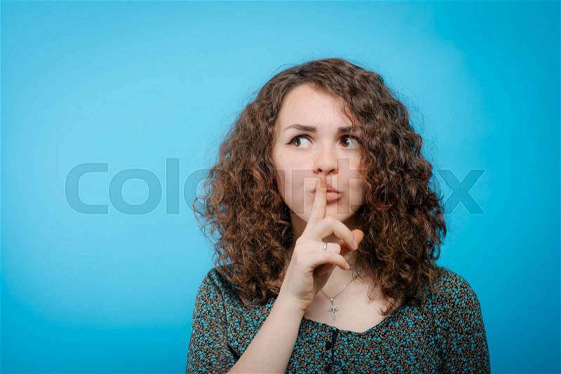 Woman put finger on her lips, stock photo