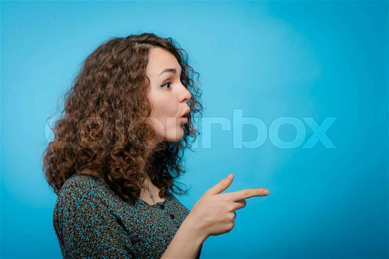 Girl points to someone the finger, stock photo