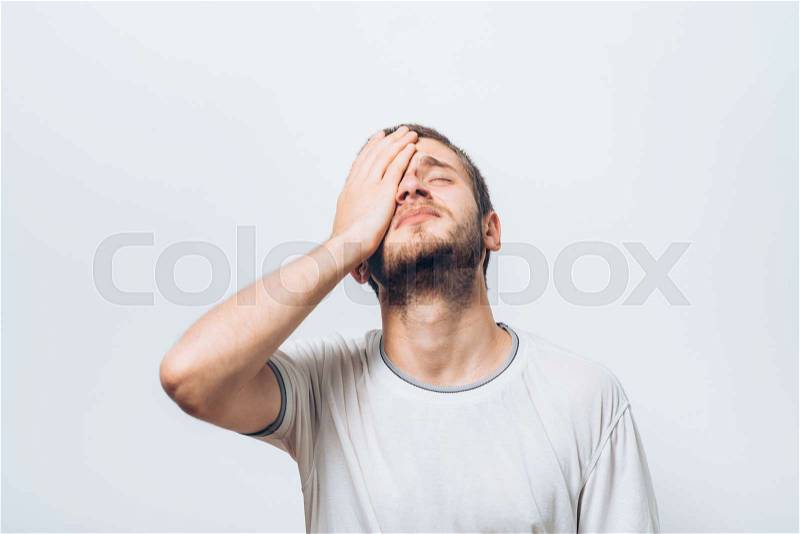 man covers his face by hand, stock photo
