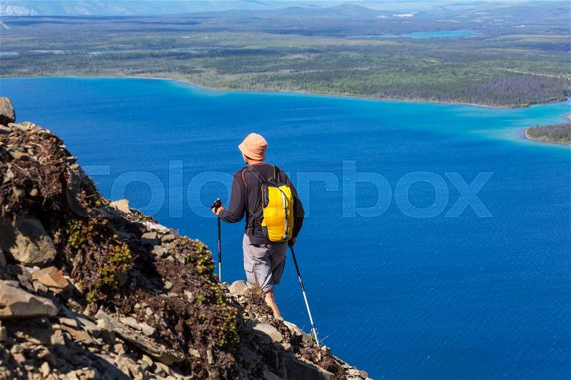 Hiking man in the mountains, stock photo