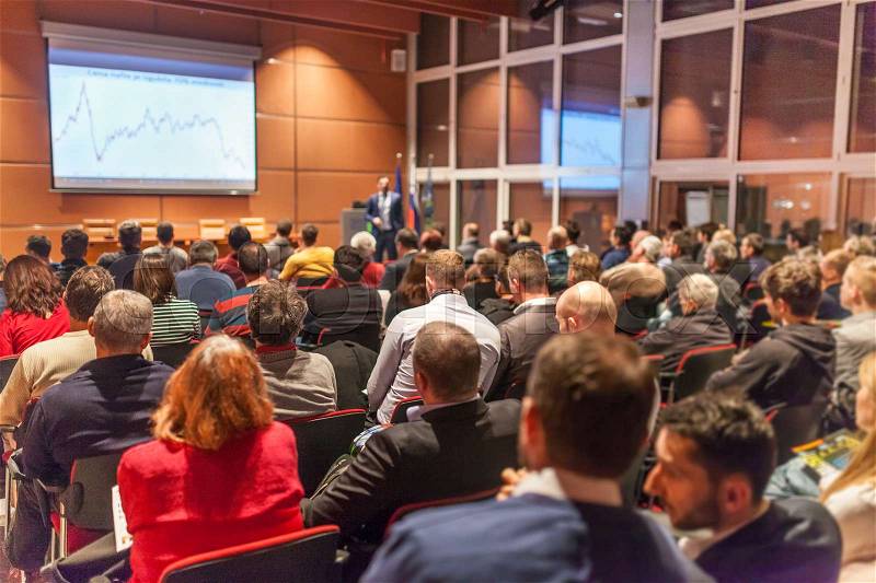 Speaker giving a talk in conference hall at business event. Audience at the conference hall. Business and Entrepreneurship concept, stock photo