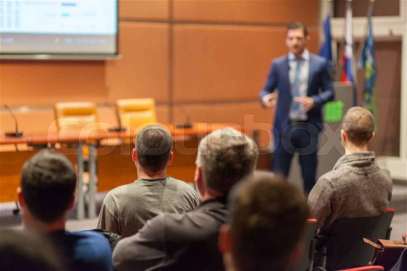 Speaker giving a talk in conference hall at business event. Audience at the conference hall. Business and Entrepreneurship concept, stock photo