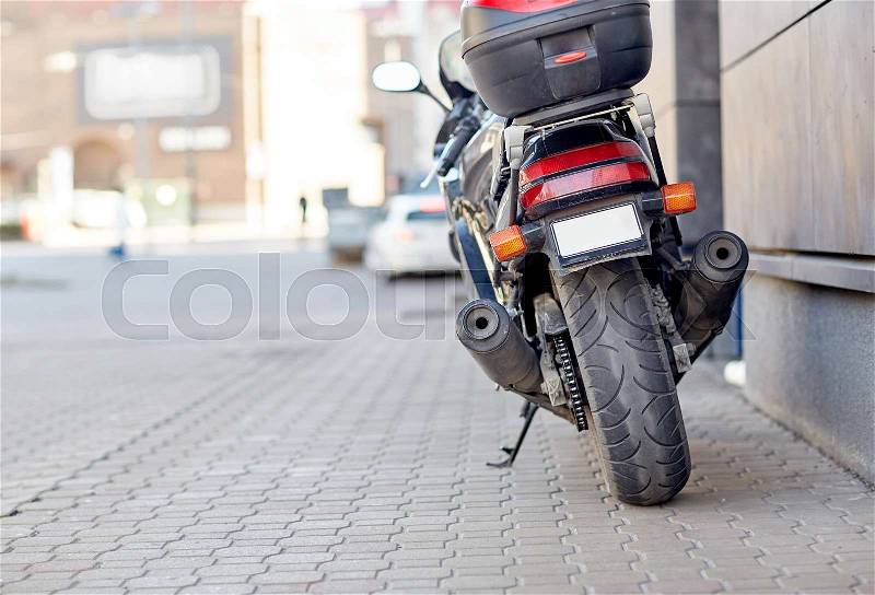 Transport, vehicle and travel concept - close up of motorcycle or bike parked on city street pavement, stock photo