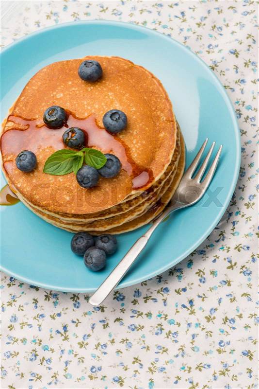 Delicious golden pancakes with fresh blackberries, stock photo