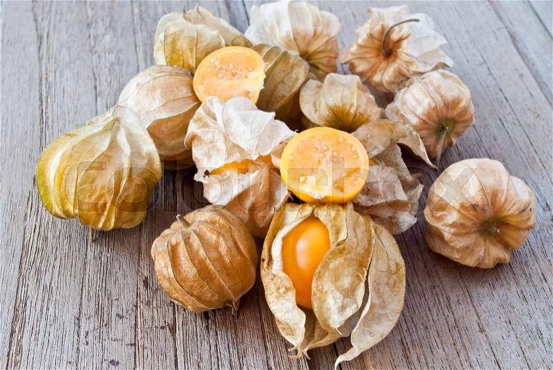 Cape gooseberry (Physalis) on wood table, healthy fruit and vegetable, stock photo