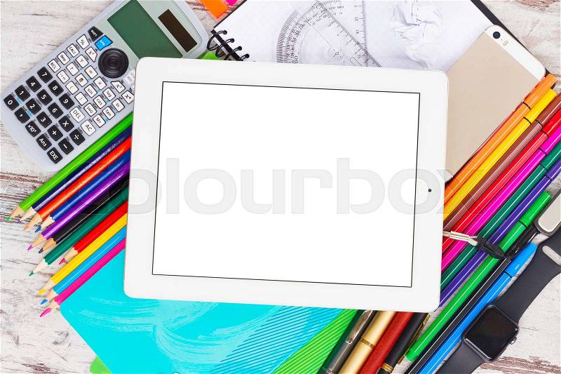 Back to school frame with school supplies and electronic device tablet with empty screen on wooden table, stock photo