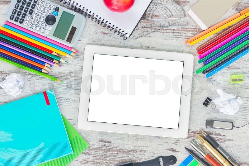 Back to school frame with school supplies, copy space on tablet with empty screen on wooden table, stock photo