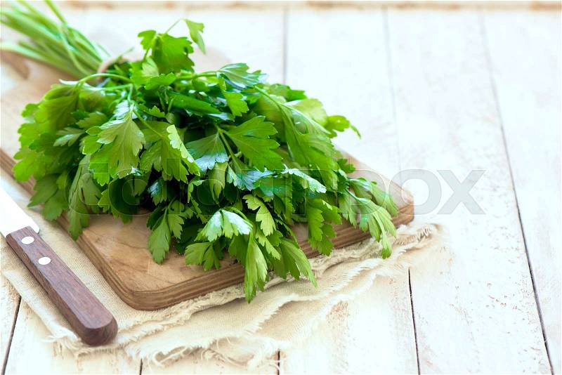 Organic italian parsley closeup on rustic wooden table, healthy vegetarian food, stock photo