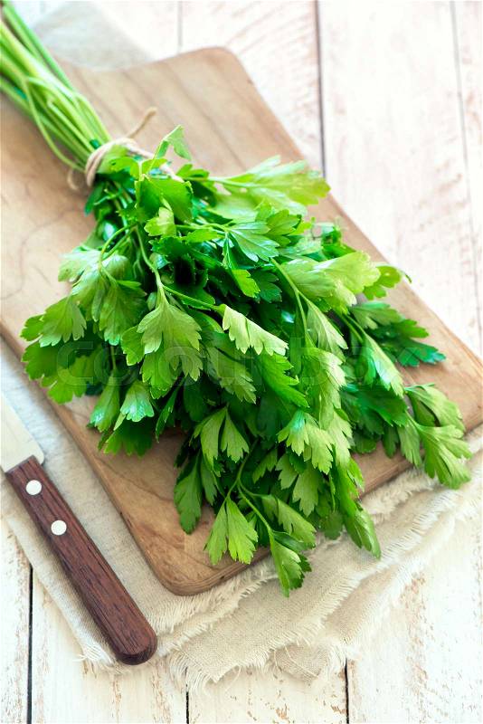 Organic italian parsley closeup on rustic wooden table, healthy vegetarian food, stock photo