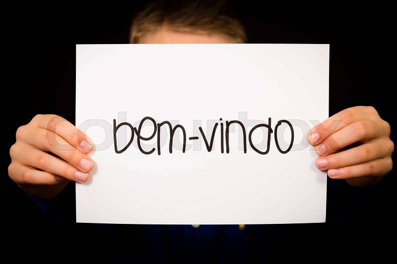 Studio shot of child holding a sign with Portuguese word Bem-vindo - Welcome, stock photo