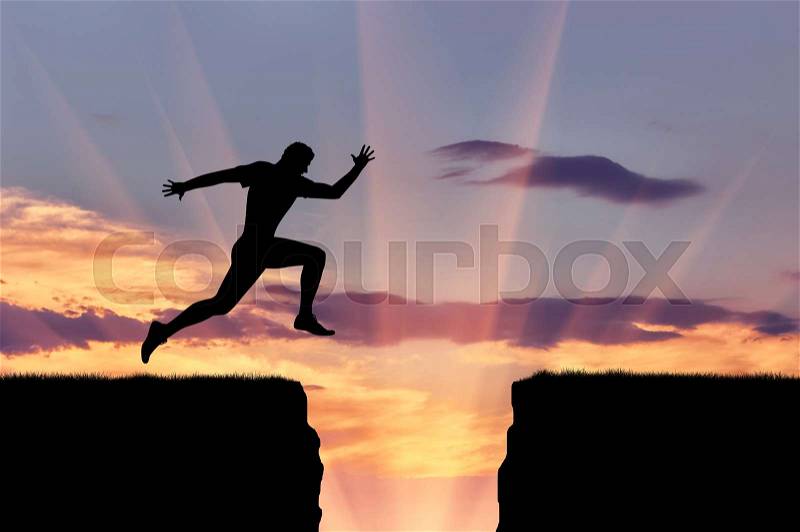 Perseverance and dedication. Runner athlete jumps over a precipice, stock photo